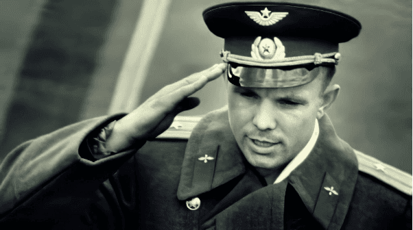 Yuri Gagarin in an officer's cap saluting