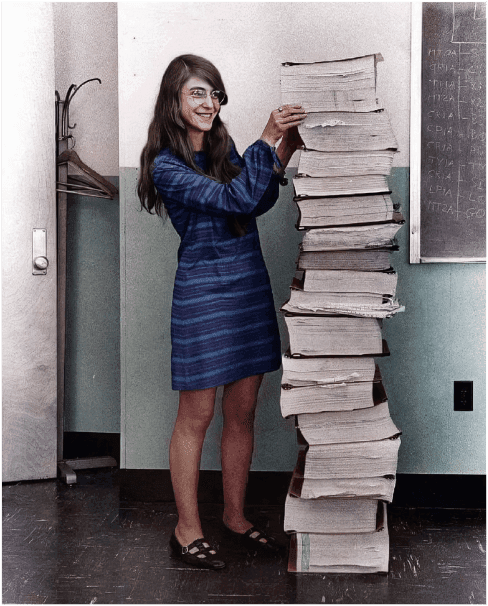 Margaret Hamilton, NASA's lead programmer for the Apollo program, next to a stack of program printouts