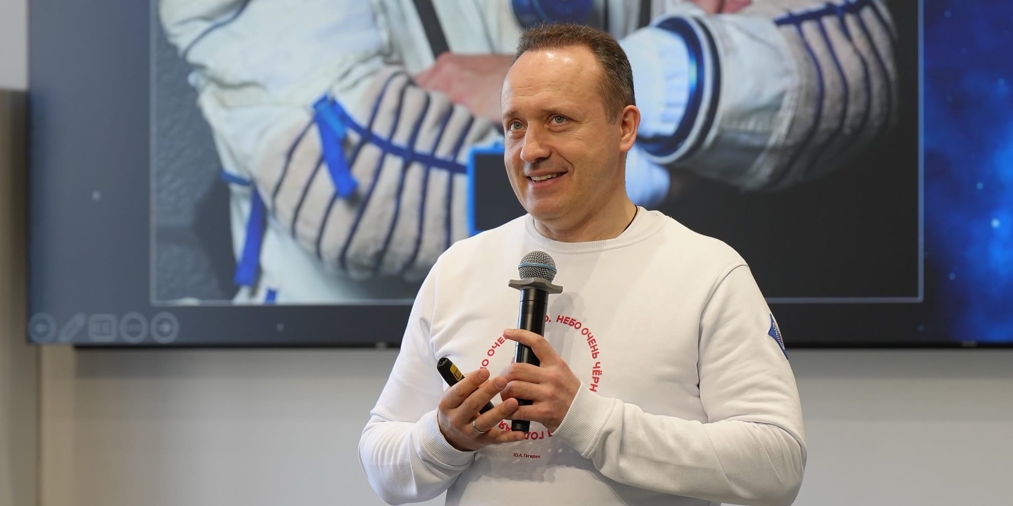 Cosmonaut Alexander Misurkin smiling at the audience during a talk
