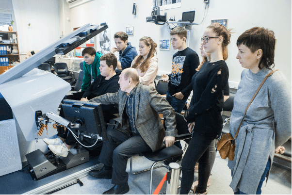 Schoolchildren at a spacecraft control simulator